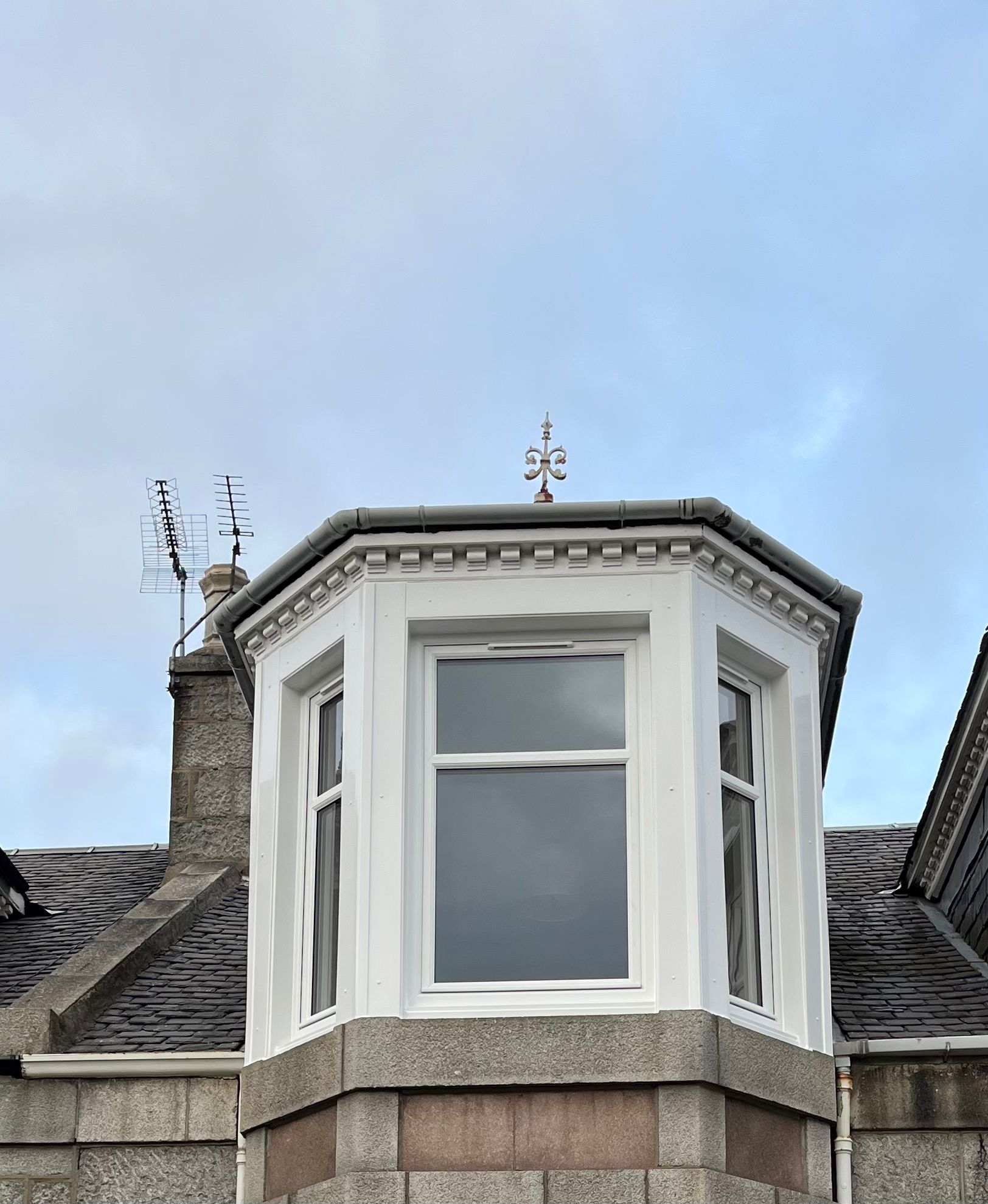 White uPVC sash bay window with ornate cornicing